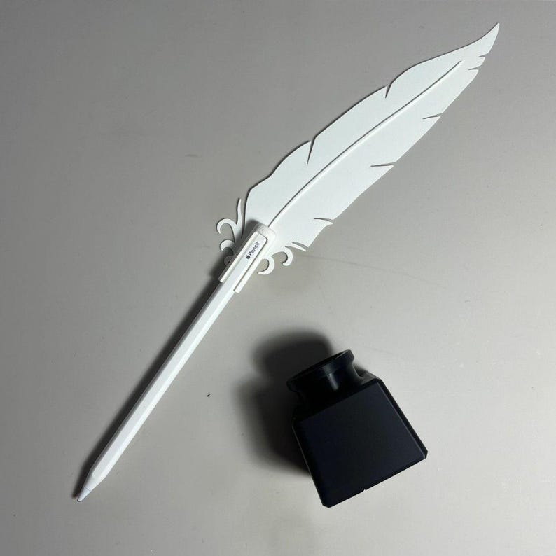 May include: A white plastic quill pen with a black ink bottle. The pen has a white plastic feather design and the words "Pencil" printed on the side.