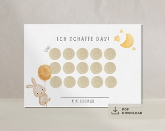 Puede incluir: Un gráfico de recompensas de estilo acuarela con el texto "ICH SCHAFFE DAS!" y "MEINE BELOHNUNG". El diseño incluye un conejito con un globo, una luna, estrellas y círculos para el seguimiento del progreso. Descarga PDF disponible.