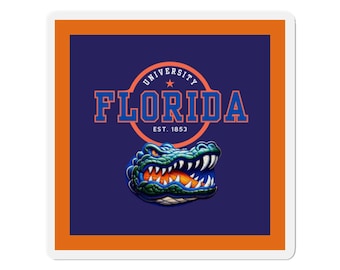 May include: A square sticker featuring a dark blue background with an orange border. The design includes the text UNIVERSITY FLORIDA EST. 1853 in orange letters inside a circle, and a detailed illustration of a green alligator head with sharp teeth.