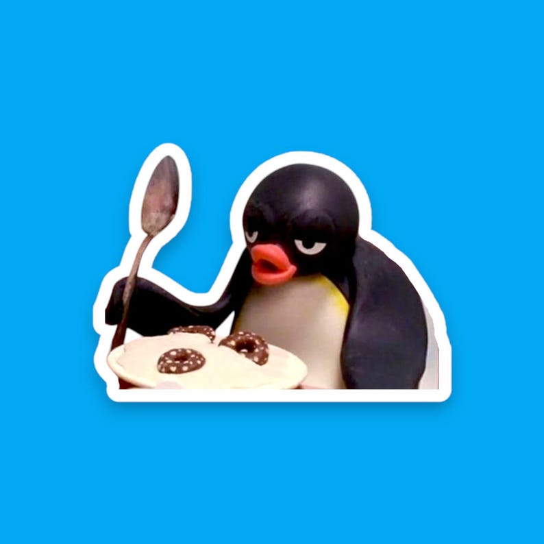 May include: A cartoon penguin with a black and white body and a red beak is holding a spoon and looking at a bowl of white pudding with chocolate sprinkles.
