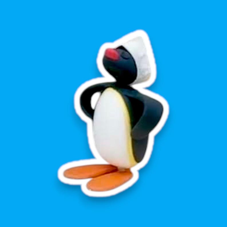 May include: A black and white penguin wearing a white hat with red cheeks. The penguin is standing on its feet with its wings outstretched.