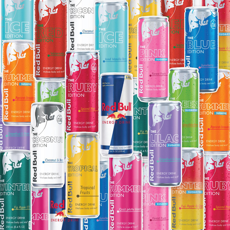 May include: A collection of Red Bull energy drink cans in various colors and flavors, including blue, pink, green, and yellow. Each can features the Red Bull logo and flavor names like "Tropical" and "Summer".