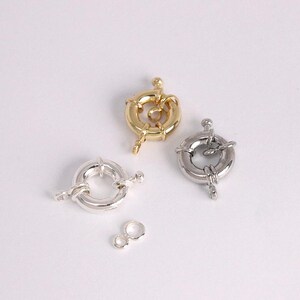 May include: An assortment of jewelry clasps in gold and silver tones. The clasps are round with a spring ring closure. Two small jump rings are also included. Ideal for jewelry making and repairs.