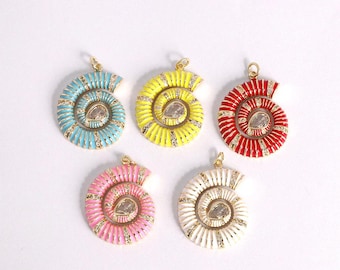 May include: Five colorful seashell pendants. Each pendant features a spiral design with a central clear stone and gold-colored accents. The pendants are in shades of blue, yellow, red, pink, and white.