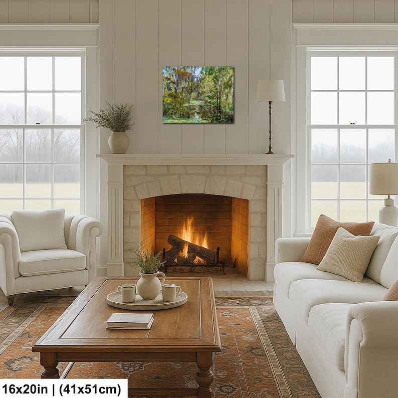 a cozy living room with a fireplace, a wooden coffee table, two white sofas, and a large window overlooking a scenic outdoor view.