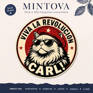 May include: A circular sticker featuring a fluffy cat wearing black sunglasses and a red beret with a white star. The text VIVA LA REVOLUCION and CARL! is printed in black around the cat. The background is a cream circle with a red center.