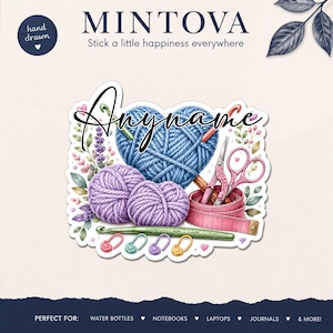 May include: A decorative sticker featuring a blue yarn heart, two purple yarn balls, a green crochet hook, pink scissors, a pink measuring tape, and four small heart-shaped stitch markers. The text "Anyname" is written in black script.