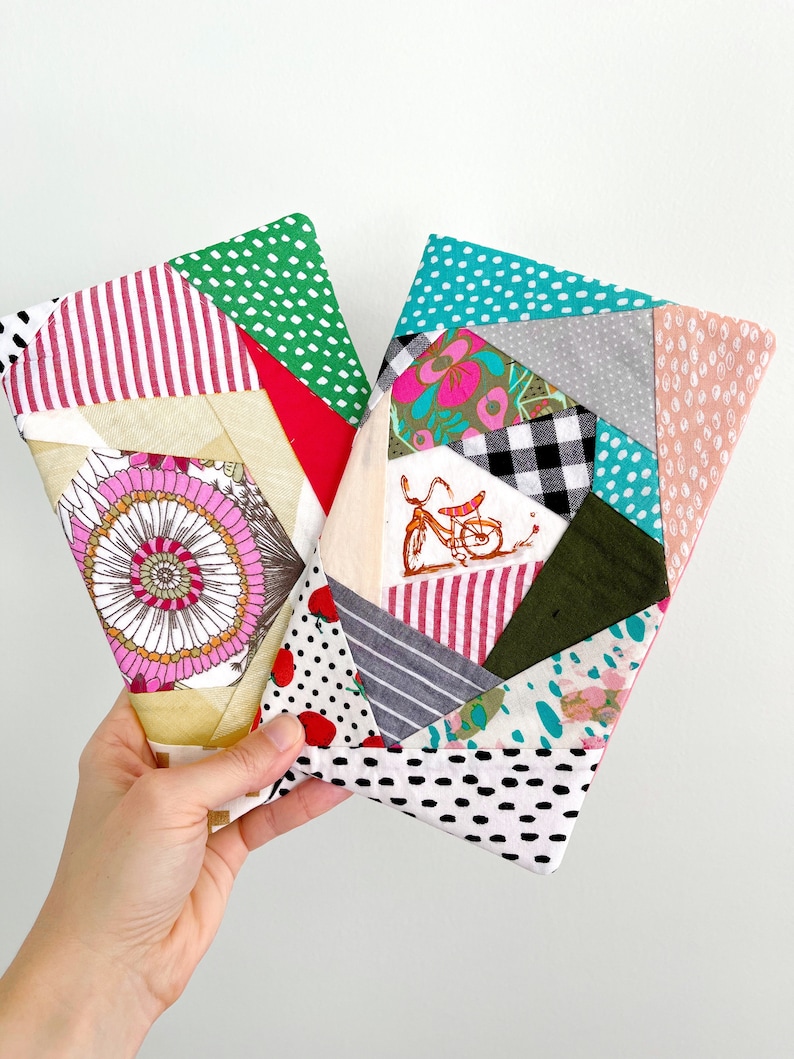May include: Two colorful patchwork fabric pouches with geometric patterns. The pouches are made of different fabrics with various prints, including polka dots, stripes, floral designs, and checkered patterns.