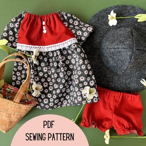 May include: A PDF sewing pattern for a child's dress, shorts, and hat. The dress is black with white daisy print, red bodice, and white lace trim. The shorts are red with a ruffled hem. The hat is gray felt with a wide brim.