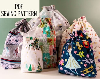 May include: A collection of six drawstring bags made from fabric with various holiday-themed prints. The bags are in different sizes and colors, including red, green, blue, white, and gray. The bags are all made from cotton fabric and have a drawstring closure. The bags are perfect for gift wrapping or for storing small items.