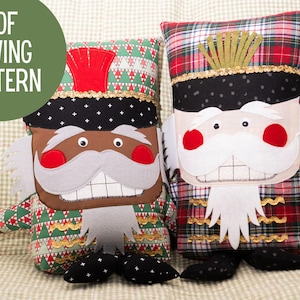 May include: Two plush toy nutcracker pillows. One is black and green with a red hat and the other is red and white with a gold hat. Both have white beards and mustaches.