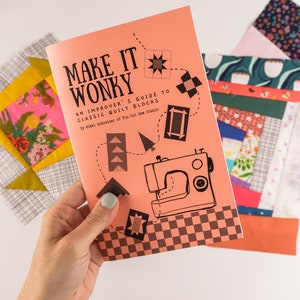 May include: A pink and orange book titled "Make It Wonky: An Improver's Guide to Classic Quilt Blocks" by  Risa  Rodrigues of  Flax & Twine Studio. The book features a sewing machine and quilt block illustrations.