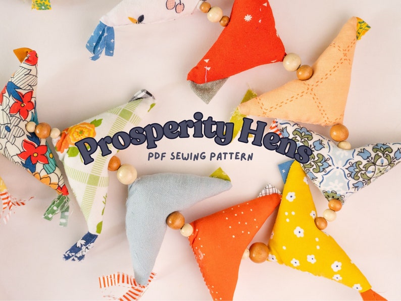 May include: A garland of colorful fabric hens with wooden beads, each hen is a different pattern and color. The garland is titled "Prosperity Hens PDF Sewing Pattern".
