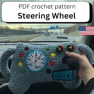 May include: A crocheted steering wheel pattern in shades of grey, blue, and various colours. The design includes a speedometer, buttons, and the word "HELLO". The text "PDF crochet pattern Steering Wheel" is displayed at the top.