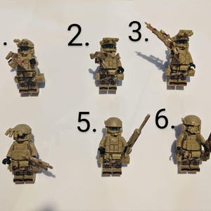 May include: Six miniature military figures with camouflage uniforms and various weapons. The figures are numbered 1 through 6.