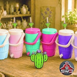 May include: A collection of colorful beverage coolers with cactus-themed straws and lids. The coolers are in shades of blue, pink, green, and purple, with white handles and spouts. A green cactus keychain and a logo are also visible.