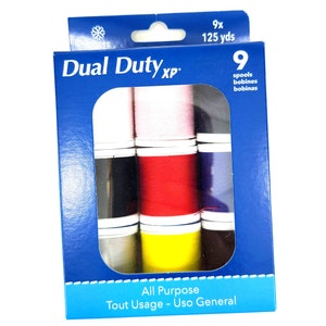 May include: A blue box of Dual Duty XP all-purpose thread. The box contains nine spools of thread in various colors, including red, black, and yellow. The box also indicates that each spool contains 125 yards of thread.