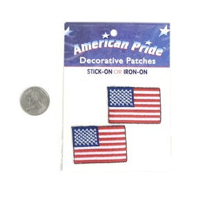 May include: Two small American flag patches on a white card with the text "American Pride Decorative Patches STICK-ON OR IRON-ON" and a quarter for size reference.