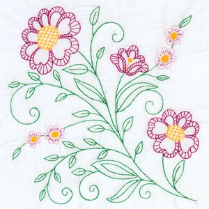 May include: A white fabric square featuring a hand-embroidered floral design. The pattern includes two large flowers with magenta petals and yellow centers, several smaller pink flowers, and intricate green stems with curling vines and leaves.