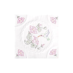 May include: White quilted fabric with embroidered floral and hummingbird design. The design features pink morning glories, green leaves, and a hummingbird with a long beak. Additional pink flowers are embroidered in each corner.