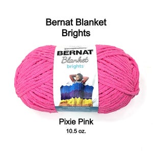 May include: A large ball of Pixie Pink Bernat Blanket Brights yarn. The label reads "Bernat Blanket brights" and features a person under a colorful blanket. The yarn weighs 10.5 oz.