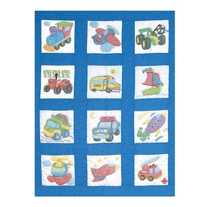 May include: A blue and white quilt with 12 squares featuring embroidered images of different vehicles, including a train, airplane, tractor, school bus, sailboat, truck, police car, helicopter, and fire truck.