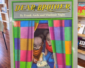 May include: A children's book titled "Dear Brother" by Frank Asch and Vladimir Vagin. The cover features two mice peeking out from behind a colorful patchwork curtain.