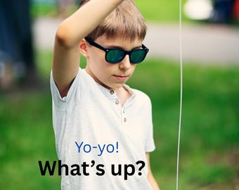 May include: A young person wearing sunglasses and a white shirt is holding a blue yo-yo. The text "Yo-yo! What's up?" is printed on the shirt. The background is a blurred green outdoor scene.
