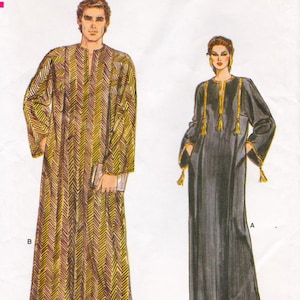 May include: Two long, flowing robes. One is a gold and brown chevron pattern, the other is black with gold trim and tassels. Both have long sleeves and a relaxed fit. The robes appear to be vintage or retro style.