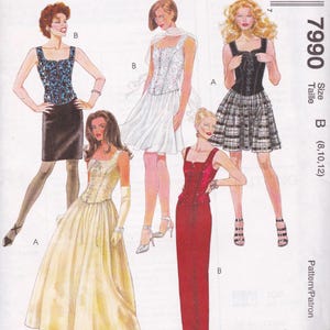 May include: A fashion illustration showcasing five dress designs. The designs include a black and white plaid skirt, a red gown, a white dress, a black top with a skirt, and a blue top with a black skirt. The text "7990" and "Size B (8,10,12)" are visible.