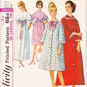 May include: A vintage Simplicity sewing pattern envelope featuring illustrations of four different robe styles. The designs include a long light blue robe, a knee-length pink gingham robe, a floral quilted robe with a bow, and a long red robe.