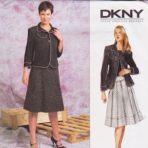 May include: A black jacket with tan trim and a matching polka dot skirt. The jacket has a single button closure and three-quarter sleeves. The skirt is knee-length. The image also includes the text "DKNY VOGUE AMERICAN DESIGNER".