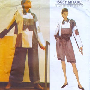 May include: A vintage Issey Miyake Vogue Designer Original sewing pattern. The pattern features a colour-blocked jacket and shorts ensemble. The jacket has white, black, and brown panels. The shorts are a dark brown colour. The pattern includes the letter designations A and B.