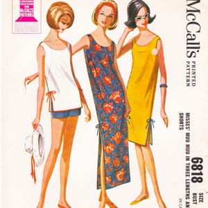 May include: Vintage McCall's sewing pattern featuring three women in 1960s-style dresses and shorts. The pattern includes a white tunic and shorts, a blue floral dress, and a yellow dress. The pattern number is 6818.