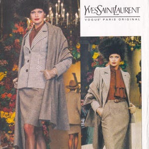 May include: A vintage fashion advertisement featuring a woman modeling a tweed skirt suit with a matching overcoat and a feathered hat. The ensemble includes a patterned blazer, a ruffled blouse, and gloves. The "Yves Saint Laurent" logo is visible.