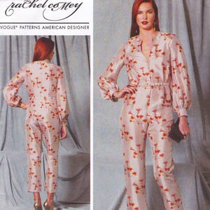 May include: A light beige jumpsuit with a floral pattern in red and orange. The jumpsuit has long sleeves, a V-neck, and a matching belt. The Vogue Patterns American Designer logo is visible in the upper left corner.