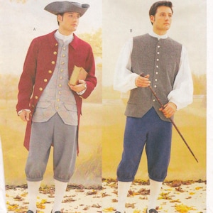May include: Two men in historical costumes. One wears a red coat with gold buttons, a gray vest, gray breeches, and a tricorn hat. The other wears a gray vest, white shirt, blue breeches, and holds a cane. Both outfits are reminiscent of the 18th century.