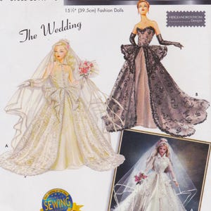 May include: A sewing pattern envelope for 15.5 inch fashion dolls titled The Wedding by Heigl & Nordstrom Designs. It features illustrations of two dolls in elaborate gowns, one in a white bridal dress with a veil and one in a black lace gown.