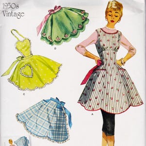 May include: Vintage apron pattern from the 1950s. The image shows several apron designs, including a green apron with pink floral accents, a yellow apron with white polka dots and a heart-shaped pocket, and a blue plaid apron.