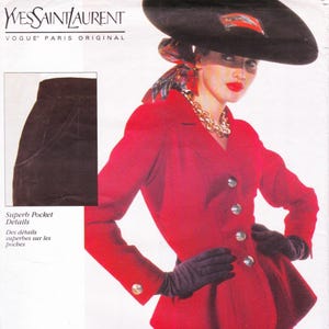 May include: A vintage fashion illustration featuring a red blazer with silver buttons, black gloves, and a large black hat. The image includes a close-up of a pocket and the Yves Saint Laurent logo.
