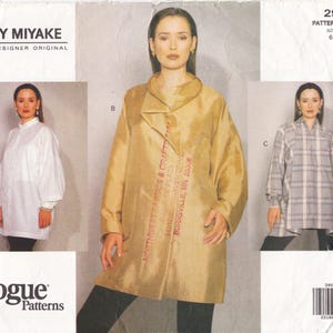 May include: A Vogue Patterns sewing pattern featuring three garment designs. The main image showcases a woman wearing a gold-colored coat with text from Northwest Fabrics & Crafts. Other images show a white shirt and a plaid top.