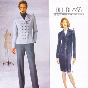 May include: A fashion illustration featuring two women's suit designs. One suit is a light gray double-breasted jacket with matching trousers. The other is a navy blue suit with a skirt and a single-breasted jacket. The text "BILL BLASS" is at the top.