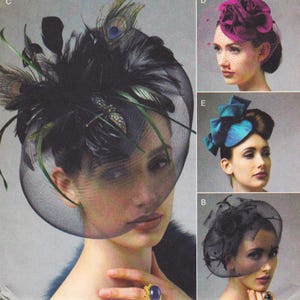 May include: A collection of elegant hats, including a black headpiece with feathers and a veil, a magenta rose-shaped hat with a veil, a teal blue bow-shaped hat, and a black hat with a rose and veil. The hats are displayed on models.