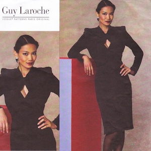 May include: A Guy Laroche Vogue Patterns Paris Original sewing pattern envelope featuring a black long-sleeved dress with structured shoulders and a central cutout at the neckline. The design displays a fitted silhouette and a knee-length hemline.