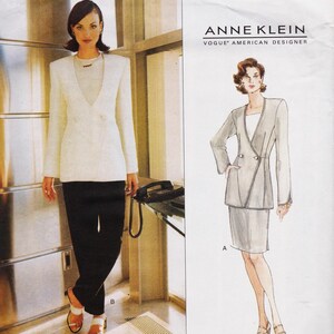 May include: A sewing pattern envelope for an Anne Klein Vogue American Designer suit featuring a double-breasted blazer and a skirt. The image displays a photograph of the finished white blazer and black trousers alongside a fashion illustration.
