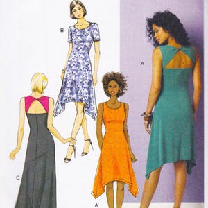 May include: A sewing pattern illustration featuring three dress variations. Style A is a sleeveless teal dress with a back cutout and handkerchief hem. Style B is a short-sleeved blue floral dress. Style C is a long dark gray dress with a pink back panel.