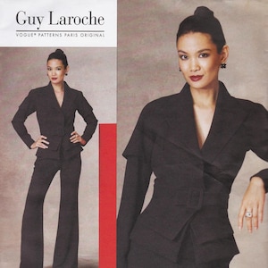 May include: A Guy Laroche Vogue Patterns Paris Original sewing pattern envelope featuring a black blazer with a notched collar, long sleeves, and a matching belt, paired with black flared trousers. The text reads Guy Laroche Vogue Patterns.