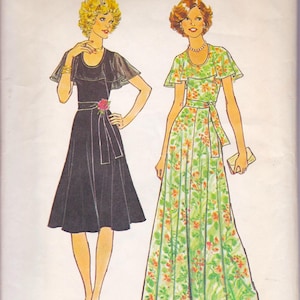 May include: Illustration of two dresses. One is a black dress with a ruffled neckline and a rose at the waist. The other is a long, floral-print dress in green and orange, with a matching belt and ruffled sleeves. Both dresses are vintage style.