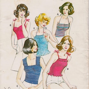 May include: A vintage sewing pattern illustration featuring five different sleeveless tops. Styles include a pink top with shoulder ties, a blue striped halter, a blue ruffled halter, a blue striped square-neck top, and a pink ruffled halter top.