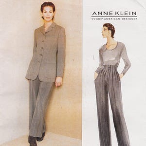 May include: A sewing pattern envelope for an Anne Klein Vogue American Designer outfit. The image displays a taupe blazer with four buttons and matching trousers, alongside a fashion illustration of a long-sleeved top and high-waisted trousers.